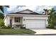 Charming single-Gathering home showcasing a well-manicured lawn and a two-car garage for convenient parking at 3549 Salvia Ct, Tavares, FL 32778
