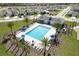 Aerial view of the community pool with plenty of lounge chairs, umbrellas and clubhouse nearby at 3549 Salvia Ct, Tavares, FL 32778