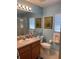 Bright bathroom featuring a single sink vanity, framed art, and walk-in shower at 4012 Capland Ave, Clermont, FL 34711