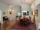 Light-filled dining area with hardwood floors, chandelier, and comfortable seating at 4012 Capland Ave, Clermont, FL 34711