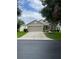 Single-story home with manicured landscaping, and a two-car garage at 4012 Capland Ave, Clermont, FL 34711
