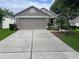 Charming single-story home with a well-maintained front yard and a spacious two-car garage at 4012 Capland Ave, Clermont, FL 34711