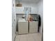 Functional laundry room with a washer, dryer, and overhead storage at 4012 Capland Ave, Clermont, FL 34711