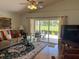 Cozy living room with sliding doors to the backyard at 4012 Capland Ave, Clermont, FL 34711
