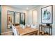 Elegant dining room with mirrors, seating for many, and modern decor at 5283 Bowspirit Way, St Cloud, FL 34771