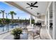 Covered outdoor kitchen and lounge area with a pool view at 5503 Banyan Bay Rd, St Cloud, FL 34771