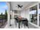 This covered patio features an outdoor kitchen, patio furniture, a ceiling fan, and natural lighting at 5688 Flame Vine Way, St Cloud, FL 34771