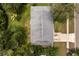 Aerial view of the home's roof, driveway, and yard surrounded by mature trees in a residential neighborhood at 575 Lake Mccoy Dr, Apopka, FL 32712