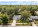 Aerial view of the home with a long driveway, a well-maintained yard, and mature trees at 575 Lake Mccoy Dr, Apopka, FL 32712