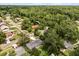 Overhead aerial of a home nestled in a lush neighborhood abundant with trees at 575 Lake Mccoy Dr, Apopka, FL 32712