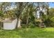 Spacious backyard featuring a storage shed, BBQ and plenty of green space for outdoor activities at 575 Lake Mccoy Dr, Apopka, FL 32712