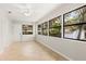 Bright bedroom with tile flooring, a ceiling fan, and natural light through large windows at 575 Lake Mccoy Dr, Apopka, FL 32712