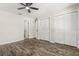 Bedroom boasts wood floors, ceiling fan, and access to an ensuite bathroom and closet space at 575 Lake Mccoy Dr, Apopka, FL 32712
