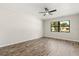 Bedroom features wood floors, bright natural light, and a ceiling fan at 575 Lake Mccoy Dr, Apopka, FL 32712