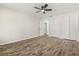 Spacious bedroom boasts wood floors, a ceiling fan, and ample closet space at 575 Lake Mccoy Dr, Apopka, FL 32712