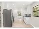 Bright kitchen features stainless steel appliances, white cabinetry, and modern backsplash at 575 Lake Mccoy Dr, Apopka, FL 32712