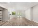 Spacious living room features sleek wood floors, recessed lighting, and French doors to the backyard at 575 Lake Mccoy Dr, Apopka, FL 32712