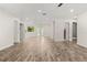 Large living space showcasing modern flooring, recessed lighting, and multiple entry points at 575 Lake Mccoy Dr, Apopka, FL 32712