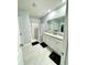 Spacious bathroom with double vanity, granite countertop, tiled floors, and a walk-in shower with a striped curtain at 577 Talisi Loop, St Cloud, FL 34771