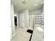 Bright bathroom featuring a walk-in shower, vanity with granite countertop, and a linen closet at 577 Talisi Loop, St Cloud, FL 34771