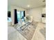 A dining area with modern table and chairs, and a textured accent wall at 577 Talisi Loop, St Cloud, FL 34771