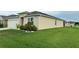 A side view shows the home's well-maintained lawn and the garage at 577 Talisi Loop, St Cloud, FL 34771