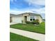 Charming one-story home featuring a two-car garage and beautifully landscaped front yard at 577 Talisi Loop, St Cloud, FL 34771