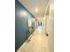 A long foyer featuring a blue accent wall and light tile flooring at 577 Talisi Loop, St Cloud, FL 34771