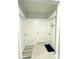 Bright hallway with three white doors, tiled floor, and neutral walls at 577 Talisi Loop, St Cloud, FL 34771