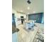 Modern kitchen featuring granite countertops, white cabinets, stainless steel appliances, and a breakfast bar with seating at 577 Talisi Loop, St Cloud, FL 34771