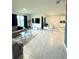 Bright open-concept living room with tile floors, modern furnishings, and large windows offering natural light at 577 Talisi Loop, St Cloud, FL 34771