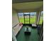 Enclosed patio with outdoor seating, offering a relaxing space with views of the fenced backyard at 577 Talisi Loop, St Cloud, FL 34771