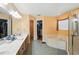 Bright bathroom with double vanity, soaking tub, and walk-in shower at 6839 Hidden Glade Pl, Sanford, FL 32771