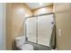 Cozy bathroom featuring toilet and shower with glass door at 6839 Hidden Glade Pl, Sanford, FL 32771