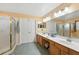 Bathroom with double sinks, walk-in shower, and warm tones for a relaxing and functional space at 6839 Hidden Glade Pl, Sanford, FL 32771