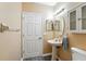 Half bathroom featuring sink and storage cabinet at 6839 Hidden Glade Pl, Sanford, FL 32771