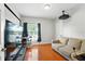 Well-lit bedroom with hardwood floors and comfortable seating area at 6839 Hidden Glade Pl, Sanford, FL 32771