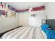 Cozy bedroom featuring a comfortable bed, neutral walls, and colorful sports-themed decor at 6839 Hidden Glade Pl, Sanford, FL 32771