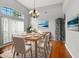 Elegant dining room featuring a modern chandelier, hardwood floors, and stylish decor at 6839 Hidden Glade Pl, Sanford, FL 32771
