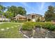 Charming single-Gathering home featuring a lush garden, manicured lawn, and inviting curb appeal at 6839 Hidden Glade Pl, Sanford, FL 32771