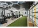 A spacious home gym features a variety of exercise equipment, artificial turf, and contemporary ceiling lights at 6839 Hidden Glade Pl, Sanford, FL 32771