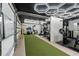 Well-equipped gym with turf, weight machines, and white board, ideal for a complete workout at home at 6839 Hidden Glade Pl, Sanford, FL 32771