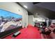 In-home theater room with projector screen, reclining seats, and black accent walls at 6839 Hidden Glade Pl, Sanford, FL 32771