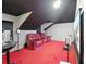 Home theater room with red carpeting, projector screen, and comfortable reclining chairs at 6839 Hidden Glade Pl, Sanford, FL 32771