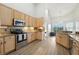 Well-equipped kitchen with stainless steel appliances, wooden cabinets, and granite countertops provides a functional space at 6839 Hidden Glade Pl, Sanford, FL 32771