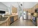 Stylish kitchen featuring stainless steel appliances, granite countertops, and breakfast bar provides a modern cooking space at 6839 Hidden Glade Pl, Sanford, FL 32771