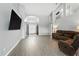 Open-concept living area with soaring ceilings, gray walls, and a comfortable reclining sofa for relaxation at 6839 Hidden Glade Pl, Sanford, FL 32771