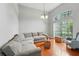 Bright living room featuring vaulted ceilings, a large window, and comfortable seating at 6839 Hidden Glade Pl, Sanford, FL 32771