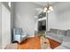 Cozy living room featuring hardwood floors, soft lighting, and comfortable seating arrangement at 6839 Hidden Glade Pl, Sanford, FL 32771