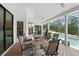 Enclosed patio with tiled flooring, outdoor furniture, and views of the swimming pool at 6839 Hidden Glade Pl, Sanford, FL 32771